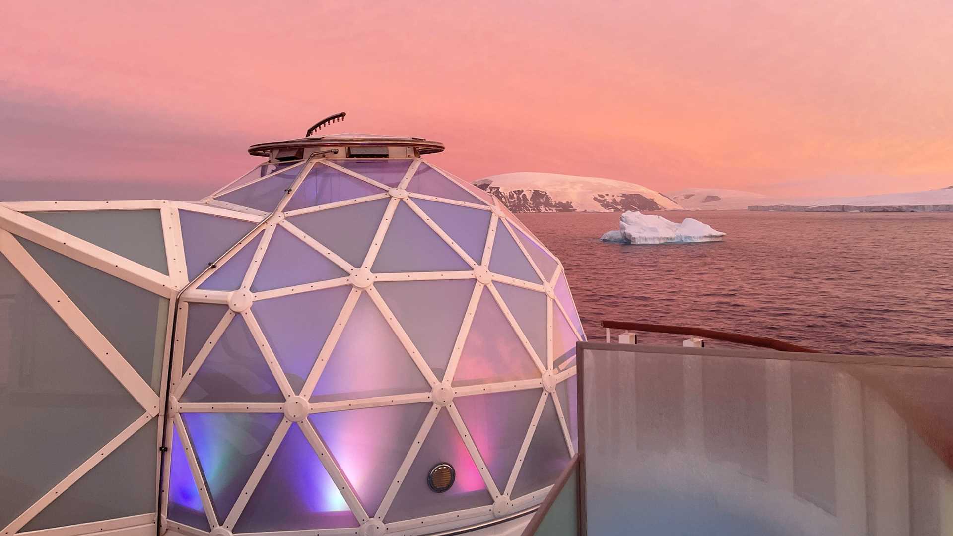 Geodesic glass igloo overlooks Antarctic landscape